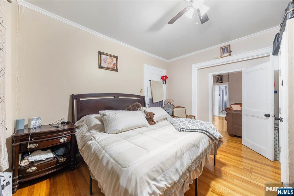 58 Park Paterson, NJ 07501 - Photo 16 of 36 a bedroom with a bed and wooden floor