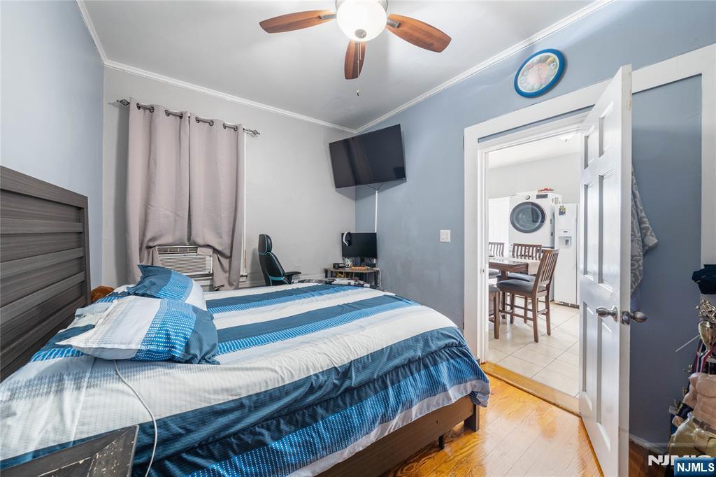58 Park Paterson, NJ 07501 - Photo 23 of 36 a bedroom with a bed and a flat tv screen on dresser