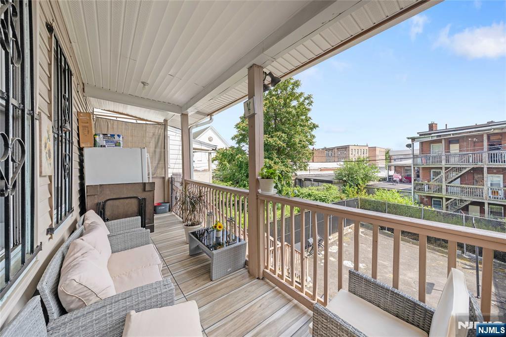 58 Park Paterson, NJ 07501 - Photo 24 of 36 a view of a balcony with couches and wooden floor