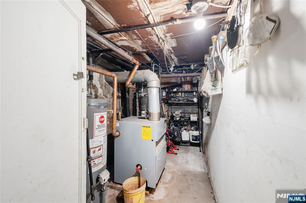 58 Park Paterson, NJ 07501 - Photo 5 of 36 a view of a storage room with water heater and racks