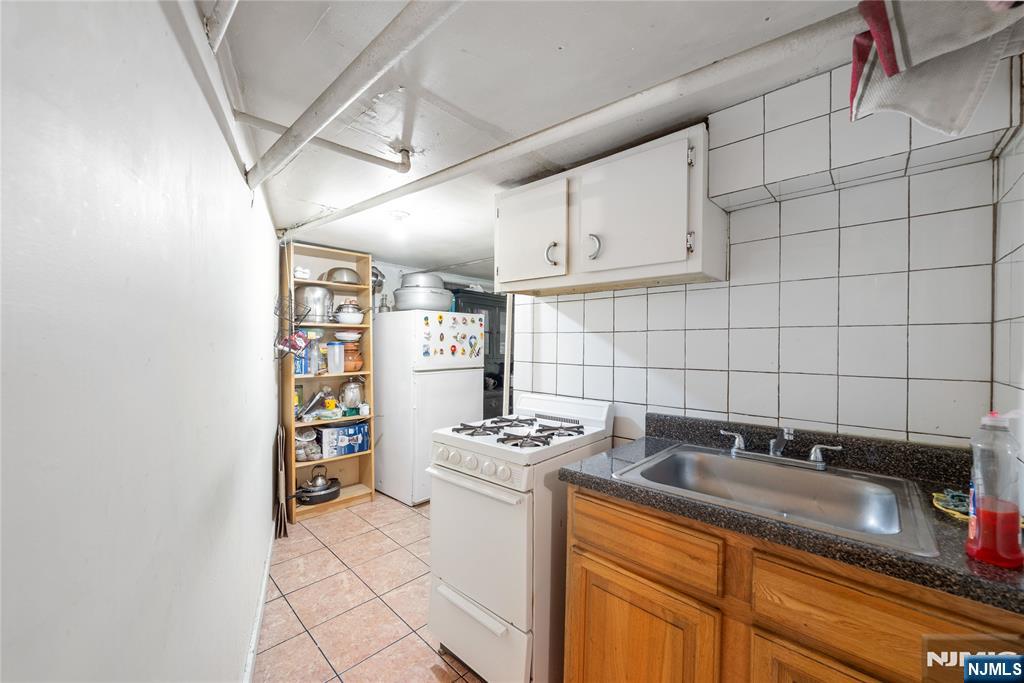 58 Park Paterson, NJ 07501 - Photo 6 of 36 a kitchen with stainless steel appliances granite countertop a sink stove and cabinets