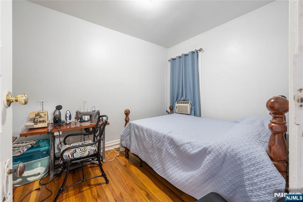 58 Park Paterson, NJ 07501 - Photo 8 of 36 a bedroom with a bed and wooden floor