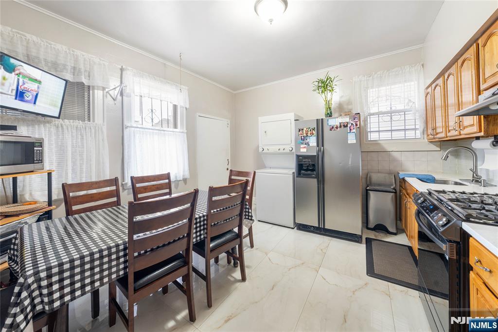 58 Park Paterson, NJ 07501 - Photo 9 of 36 a kitchen with stainless steel appliances kitchen island granite countertop a refrigerator and microwave