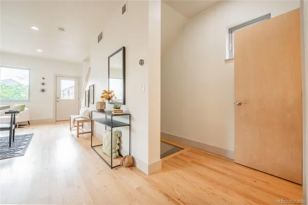 a view of a living room with furniture and wooden floor