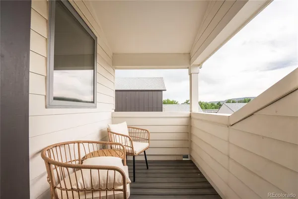 a view of a porch with furniture and wooden floor