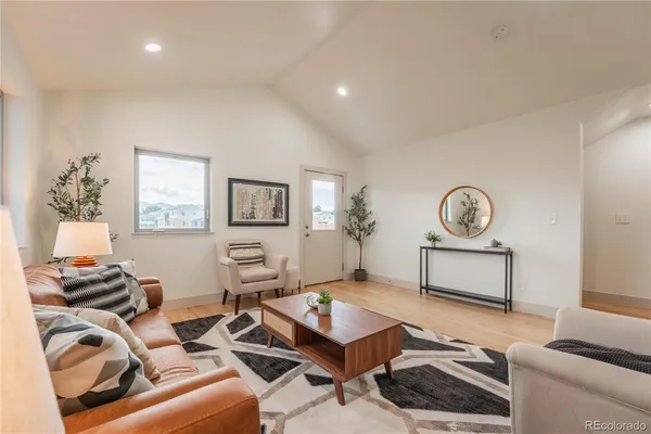 a living room with furniture a couch and a window