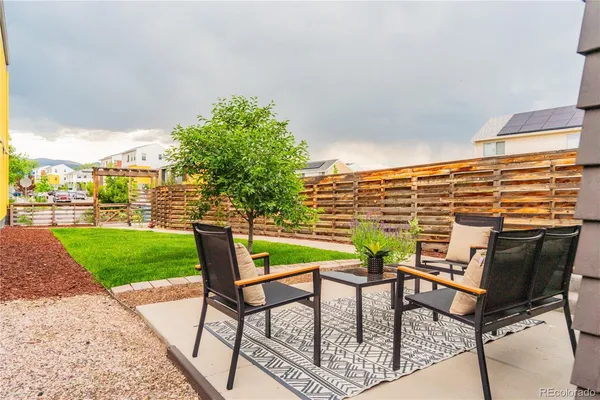 a view of a patio with a table and chairs