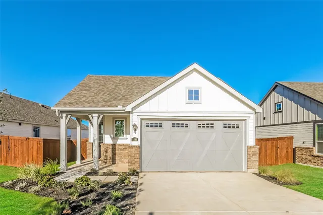 a view of a white house with a big yard and large trees