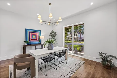a bedroom with a large bed and a potted plant