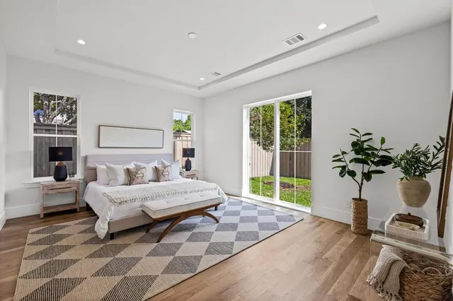 a bedroom with a bed and a potted plant