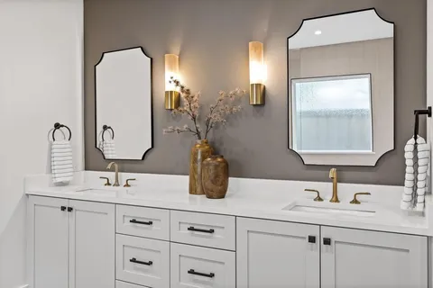 a bathroom with a double vanity sink and mirror