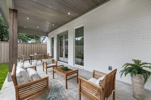 a view of a patio with a table chairs and a backyard