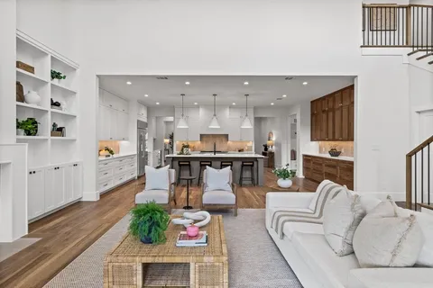 a living room with furniture and kitchen view