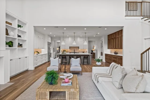 a living room with furniture and kitchen view