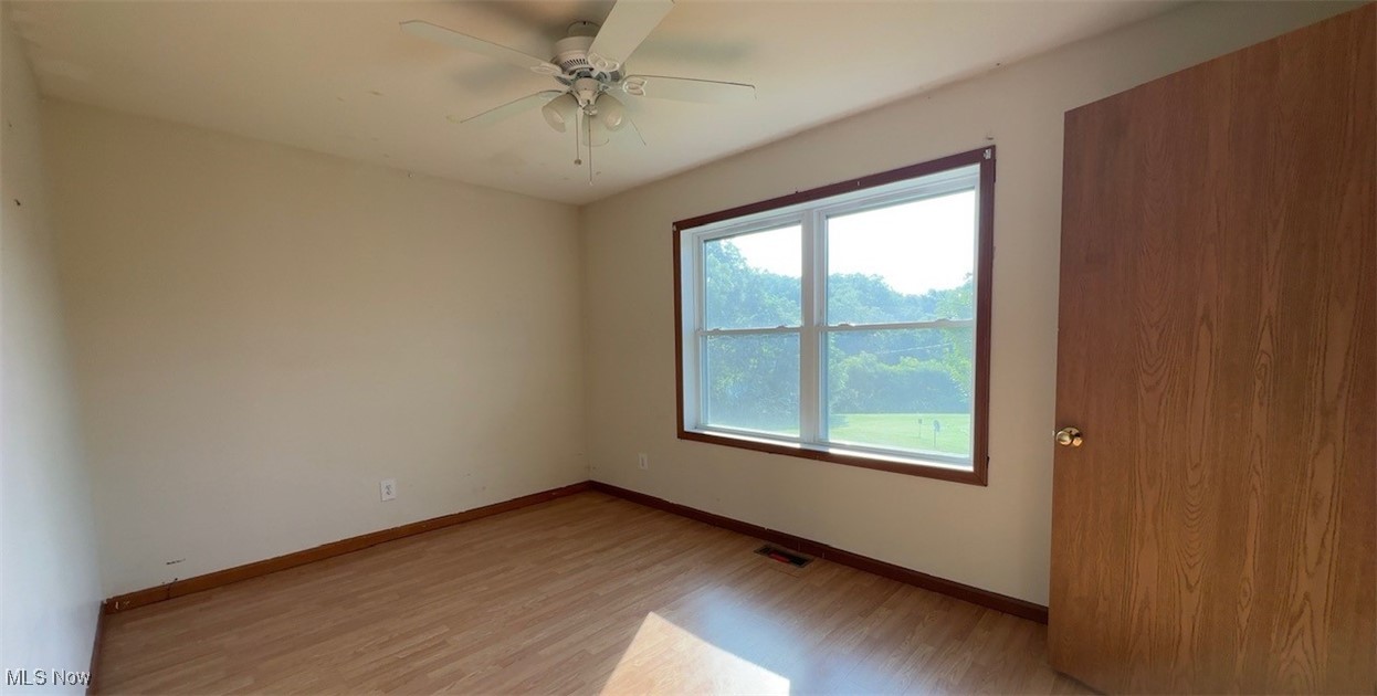 4965 Workman Road Roseville, OH 43777 - Photo 9 of 10 Unfurnished bedroom with light wood-style floors and ceiling fan