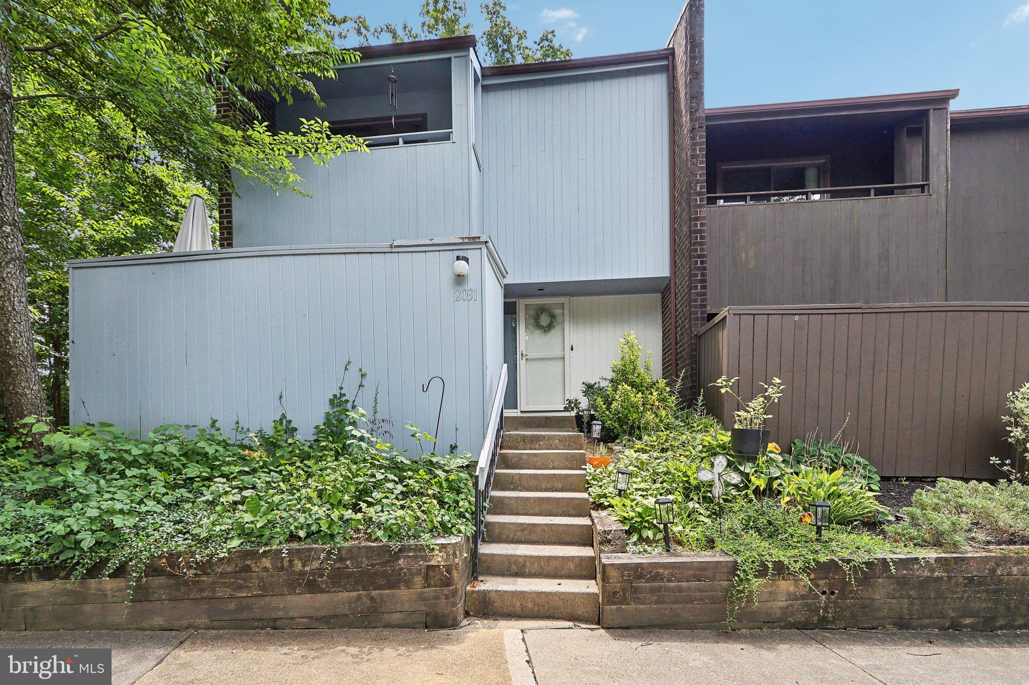 2031 Approach Lane Reston, VA 20191 - Photo 2 of 58 Charming home with lush greenery.