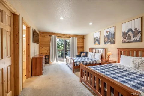 a bedroom with furniture and large window
