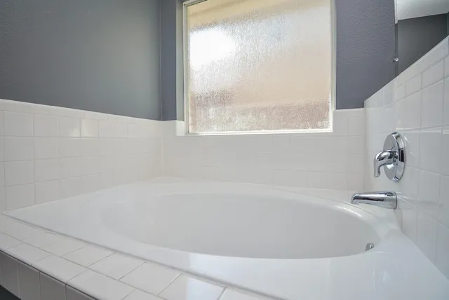 a white bath tub sitting next to a window