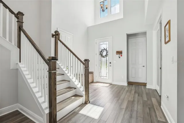 a en suite bathroom with a granite countertop sink a mirror and shower