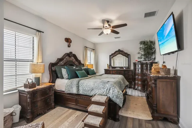 a bedroom with a bed and a chandelier