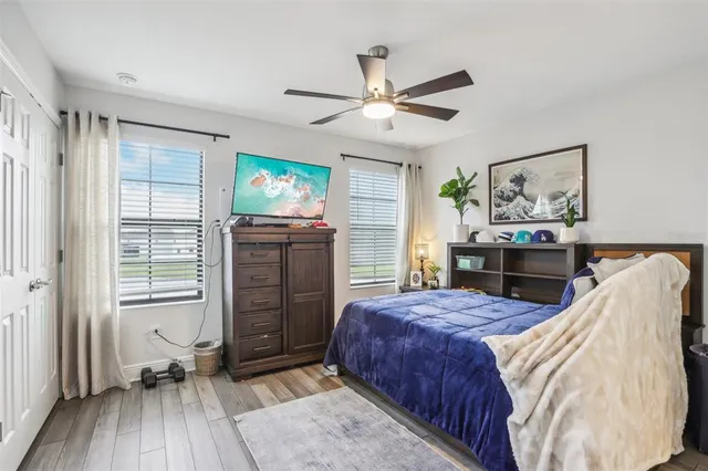 a white bath tub sitting next to a bathroom sink and a window