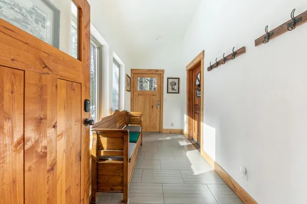 a living room with furniture a fireplace and a large window