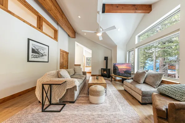 a kitchen with a table chairs refrigerator and microwave