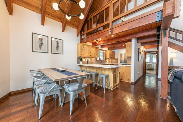 a kitchen with stainless steel appliances granite countertop a sink a stove and a wooden floors