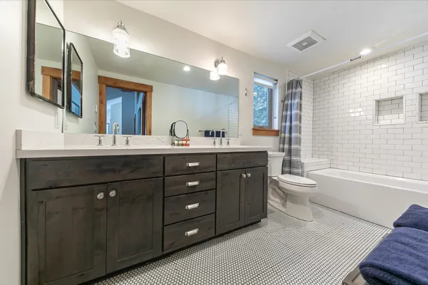 a bedroom with a bed chair and a window