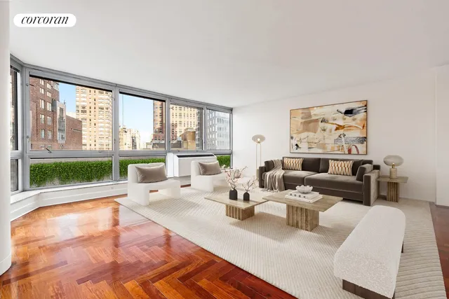 a living room with furniture large windows and wooden floor