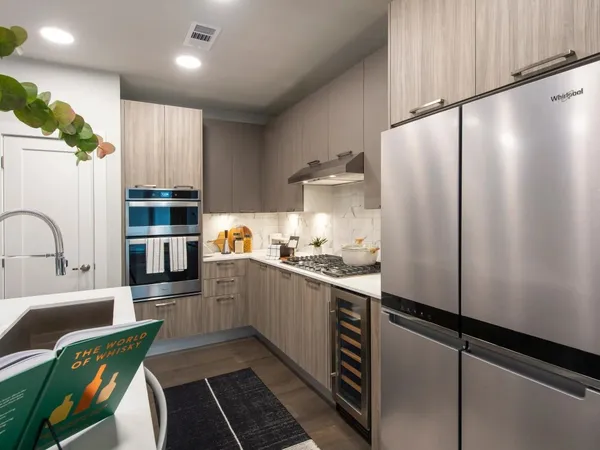 a kitchen with stainless steel appliances a refrigerator sink and cabinets
