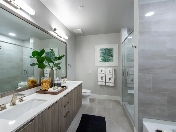 a bathroom with a double vanity sink and a mirror