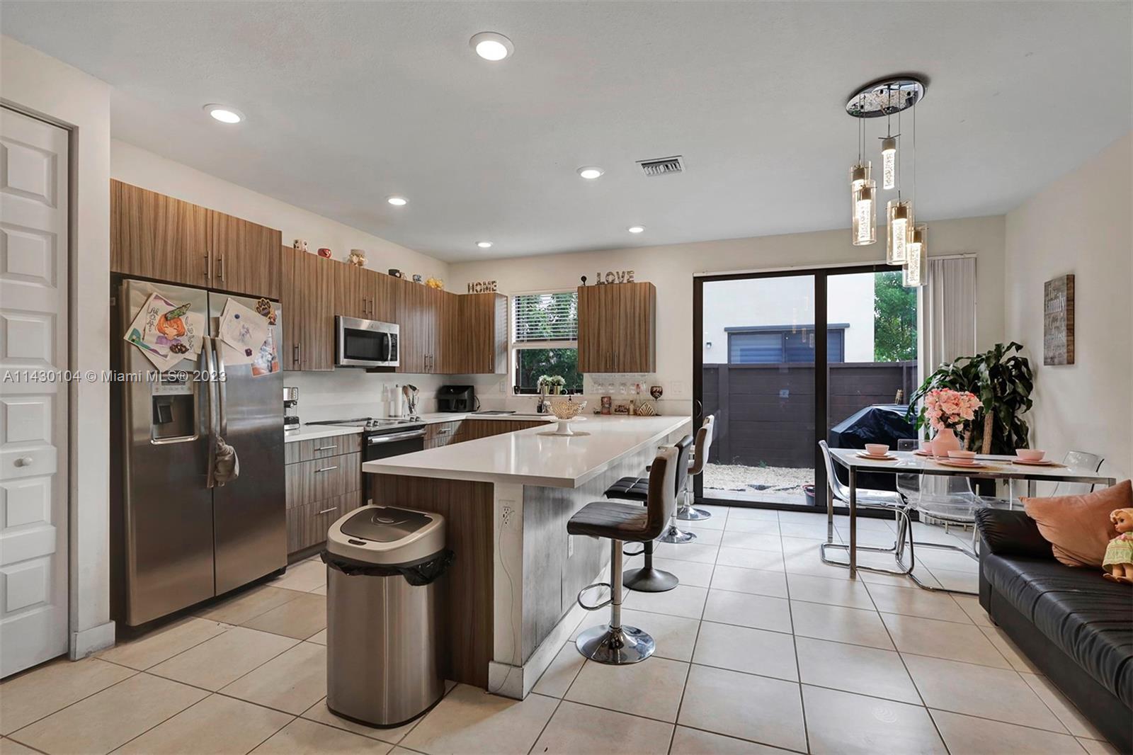 a kitchen with stainless steel appliances kitchen island granite countertop a sink a counter top space and stainless steel appliances