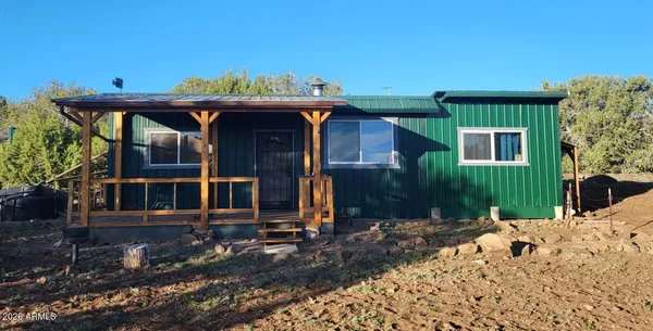 a view of a house with wooden fence
