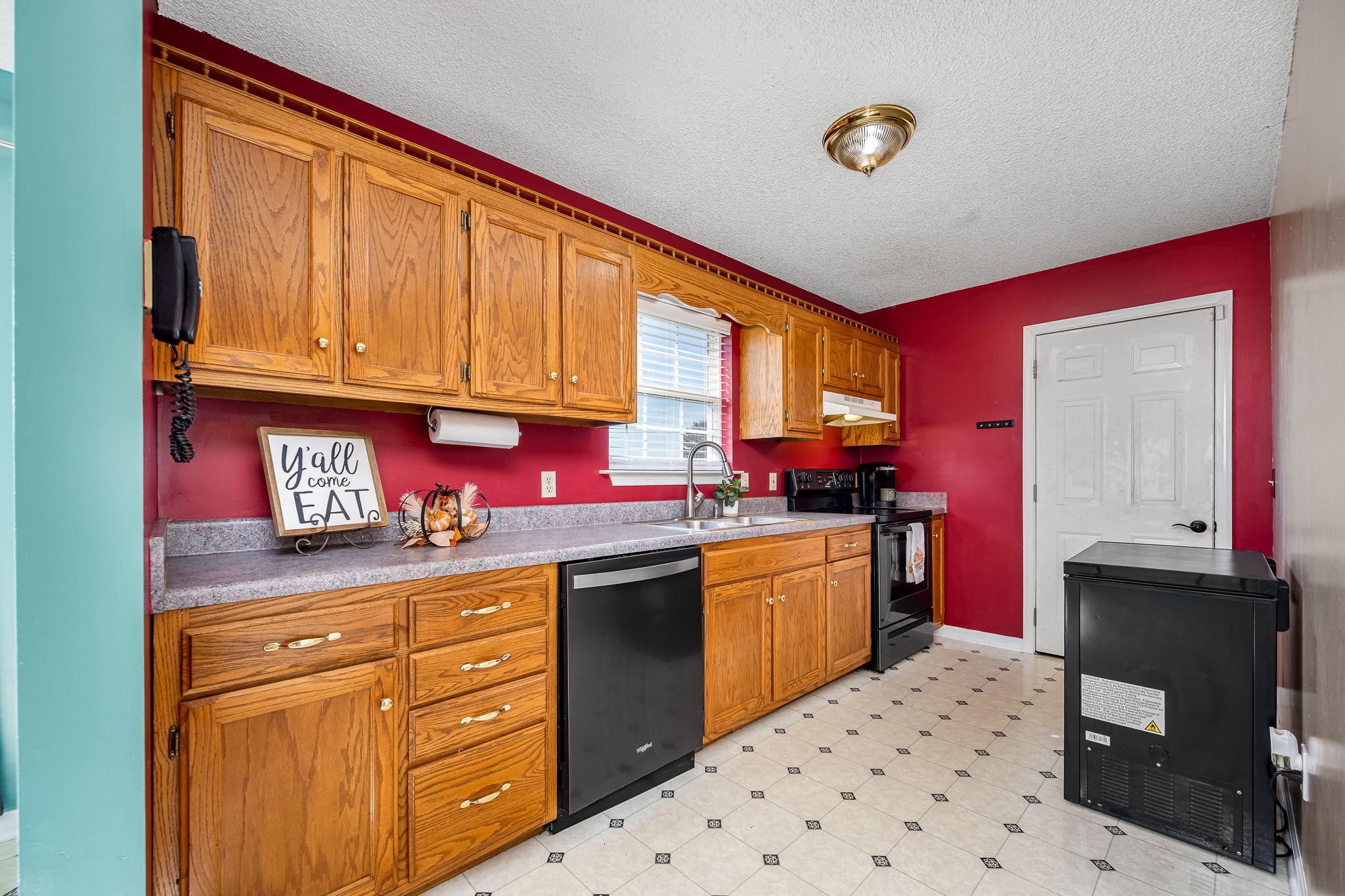 2936 Midland Road Shelbyville, TN 37160 - Photo 21 of 46 a kitchen with granite countertop a sink cabinets stainless steel appliances and a window