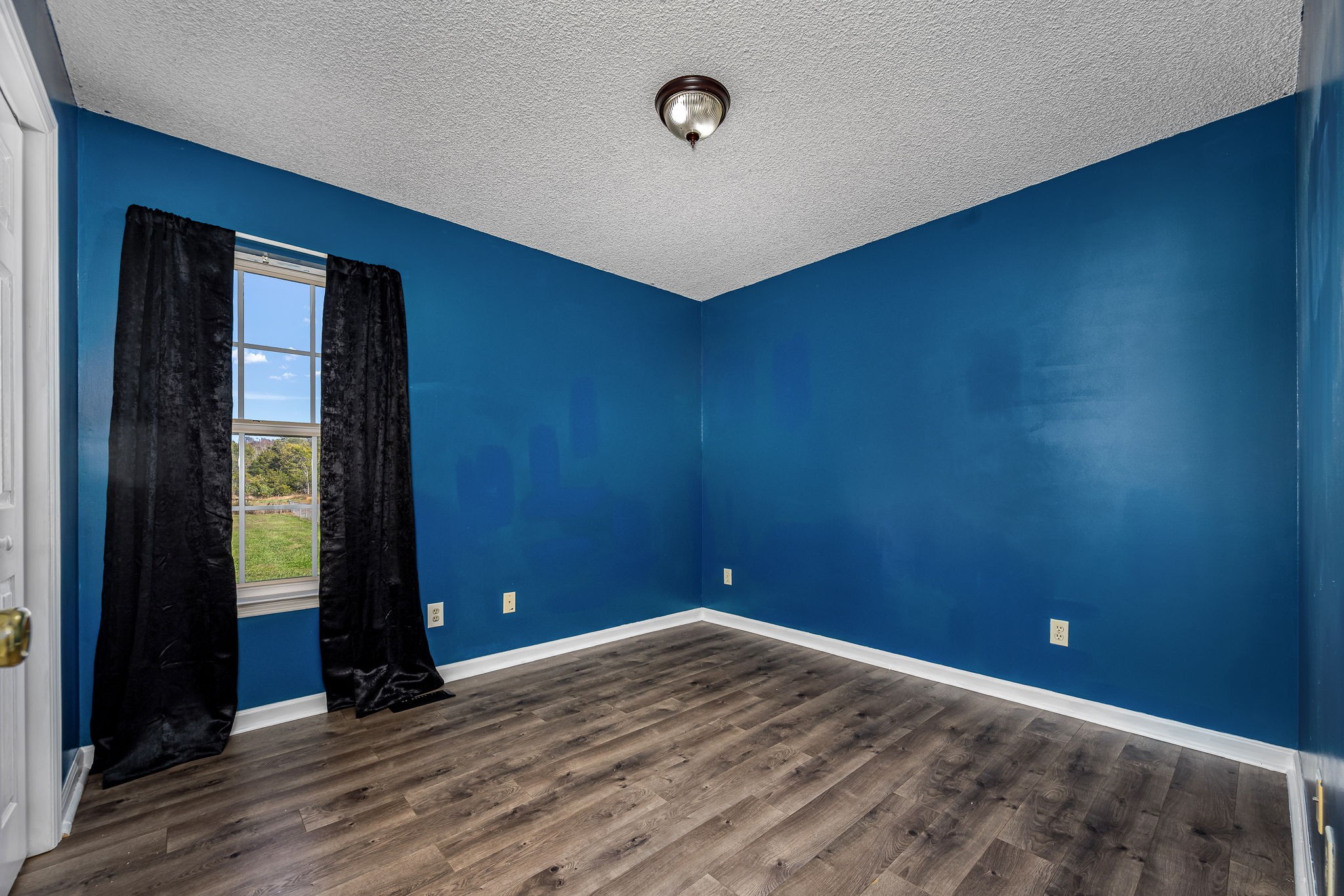 2936 Midland Road Shelbyville, TN 37160 - Photo 31 of 46 an empty room with wooden floor and windows