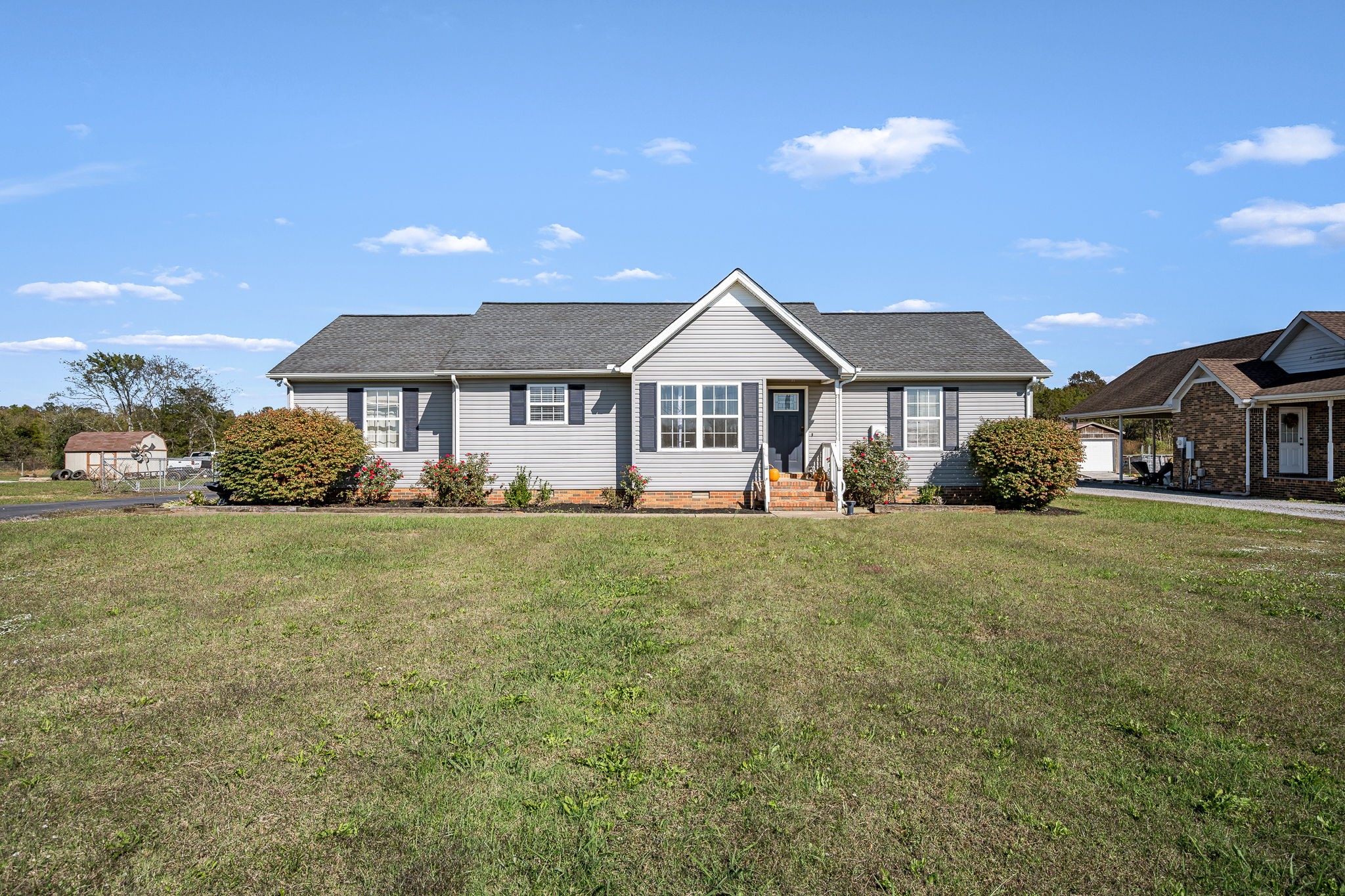 2936 Midland Road Shelbyville, TN 37160 - Photo 7 of 46 a front view of a house with a garden and plants