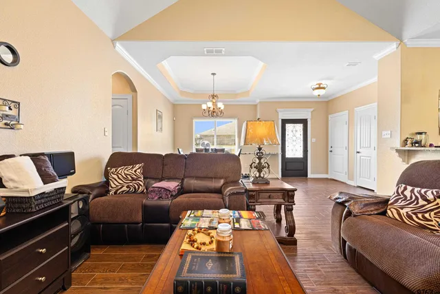 a living room with furniture and a chandelier