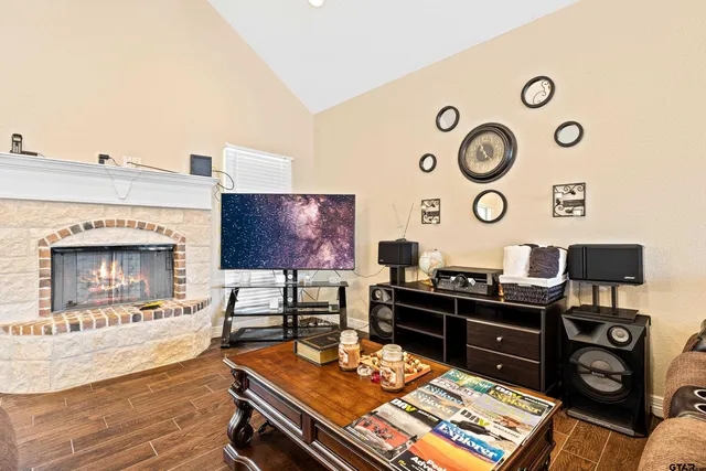 a living room with furniture a fireplace and a flat screen tv