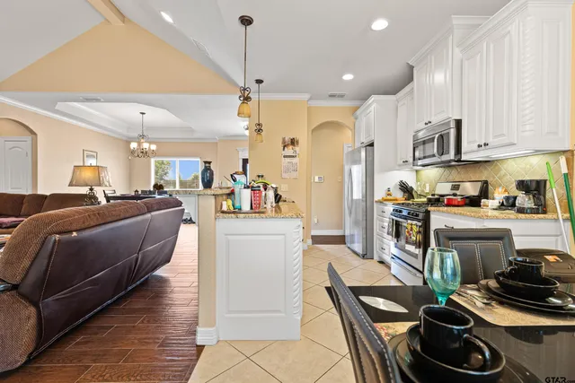a living room with furniture and kitchen view