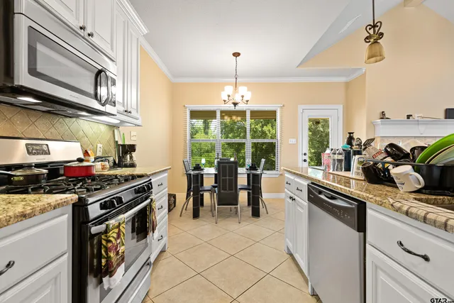 a kitchen with a stove a sink and a dining table