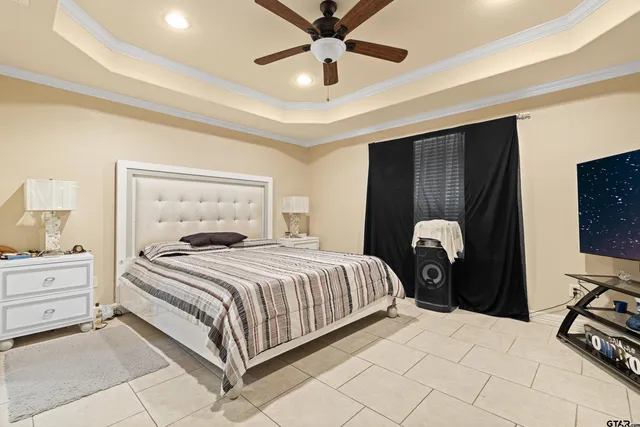 a bedroom with bed and a chandelier