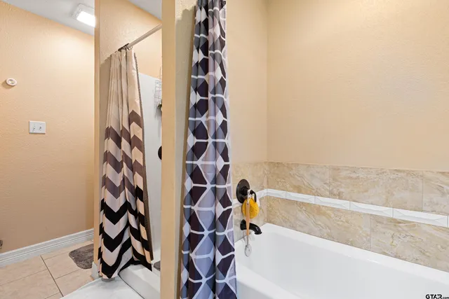 a bathroom with a bathtub and shower