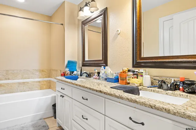 a bathroom with a bathtub and a sink