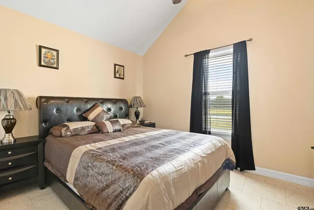 a bedroom with bed and window