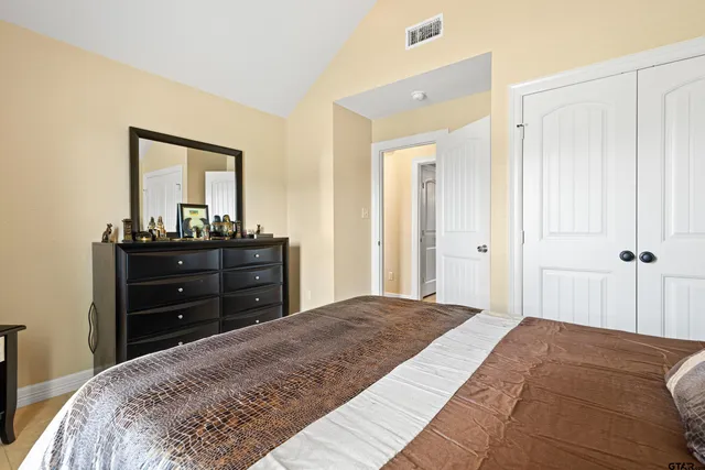 a bedroom with a bed and a dresser