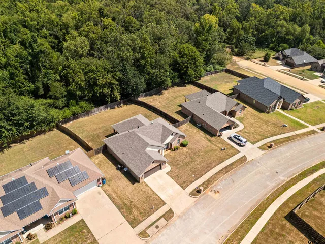 an aerial view of a house with a yard
