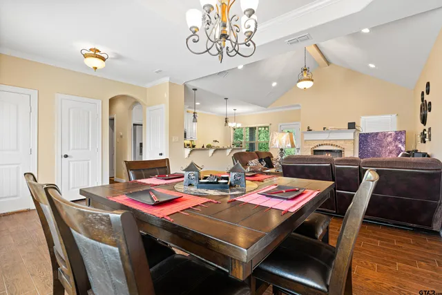 a dining room with furniture and wooden floor
