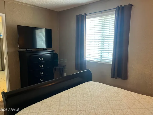 a bedroom with a bed and a lamp