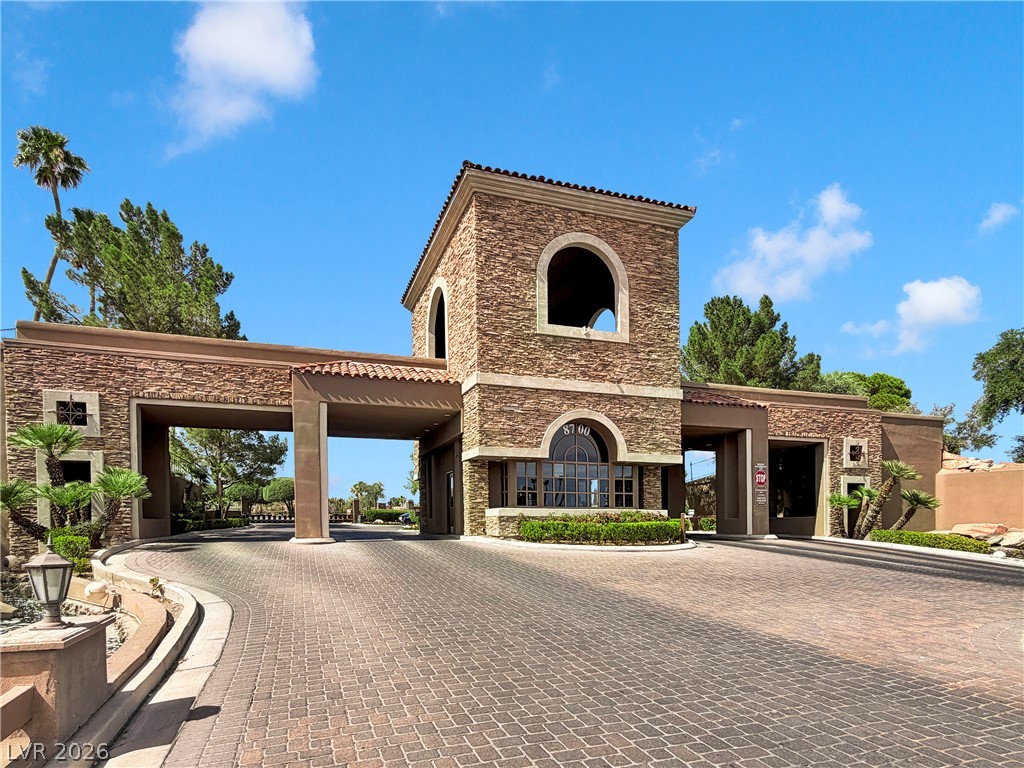 8981 Rivers Edge Drive Las Vegas, NV 89117 - Photo 54 of 69 Secure community entrance with substantial stone architecture and a broad paved drive.